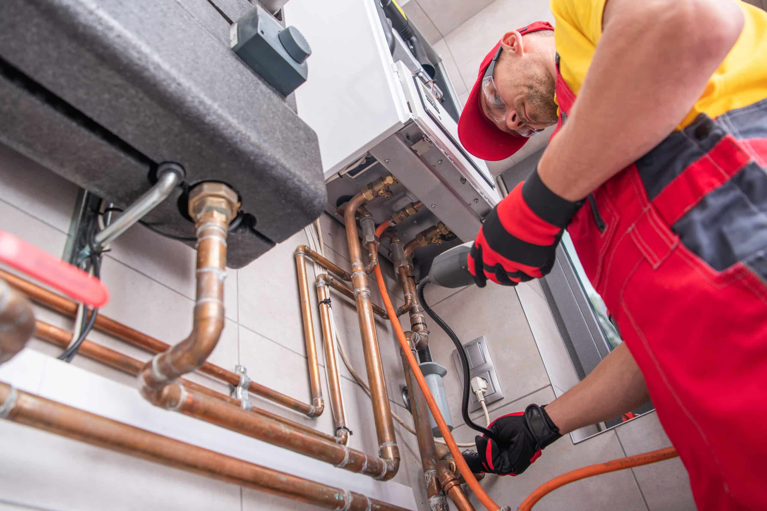 An HVAC professional tests the gas on a residential gas furnace 