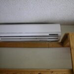A sleek ductless mini-split affixed to the wall, enhancing indoor comfort with its cooling capabilities.