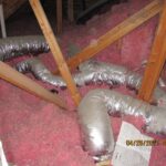 visible duct work throughout insulation in an attic