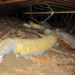 an attic displaying visible ductwork and pipes
