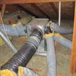 A view of an attic showcasing a network of pipes and ducts forming a comprehensive duct system.