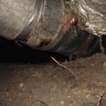 image of pipes under a house