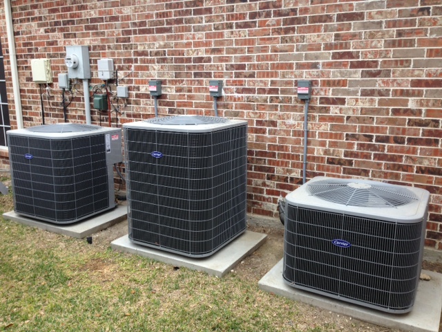 three residential outdoor trane HVAC units