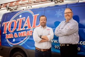 Steve Lauten and his son Justin standing in front of a Total Air van