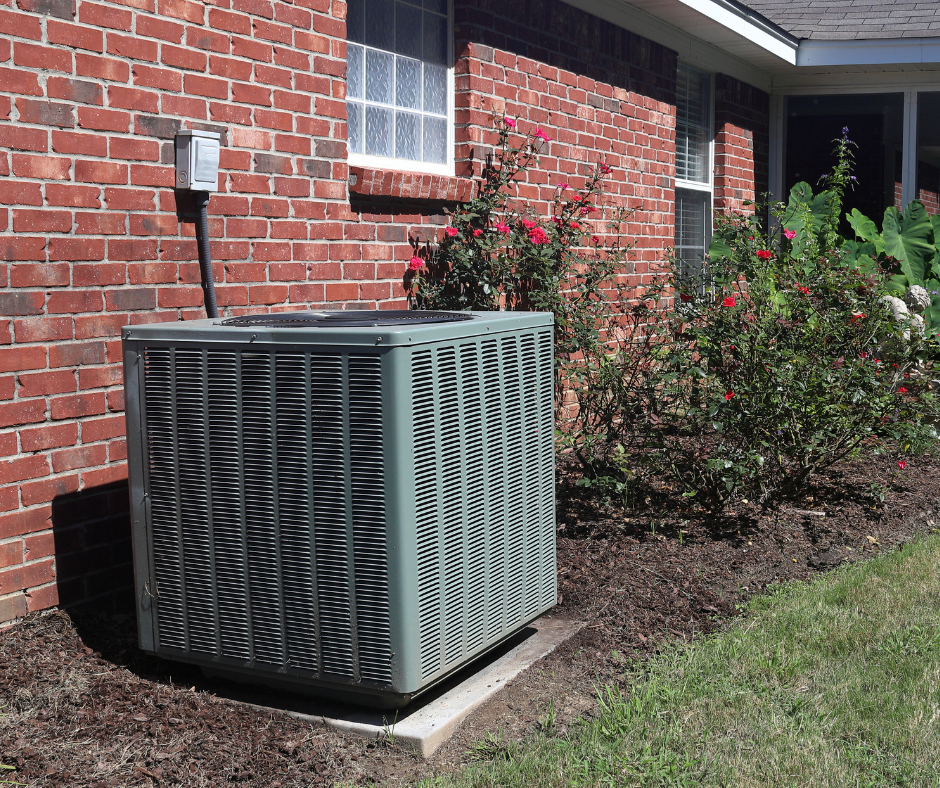 An HVAC unit sits outside of a home in what appears to be spring