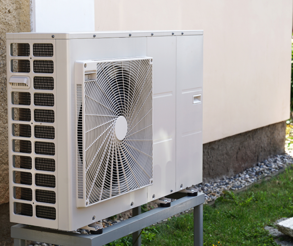 The outdoor component of a heat pump outside of a home