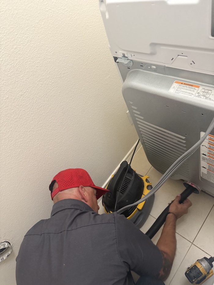 Total Air technician cleaning a dryer vent in Plano, TX