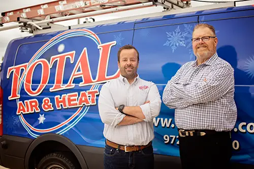 Steve and Justin Lauten, owners of Total Air & Heat in Plano and Dallas, TX, standing in front of service van